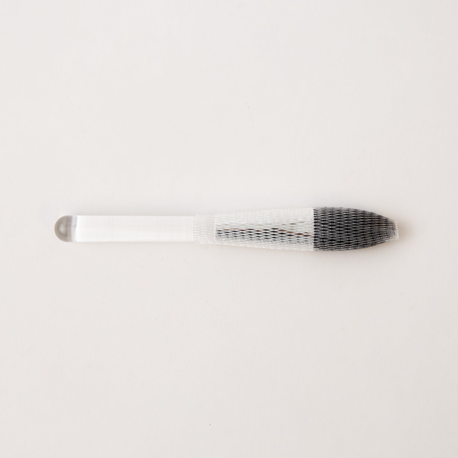 Metallic butter knife with a textured handle on a light gray background