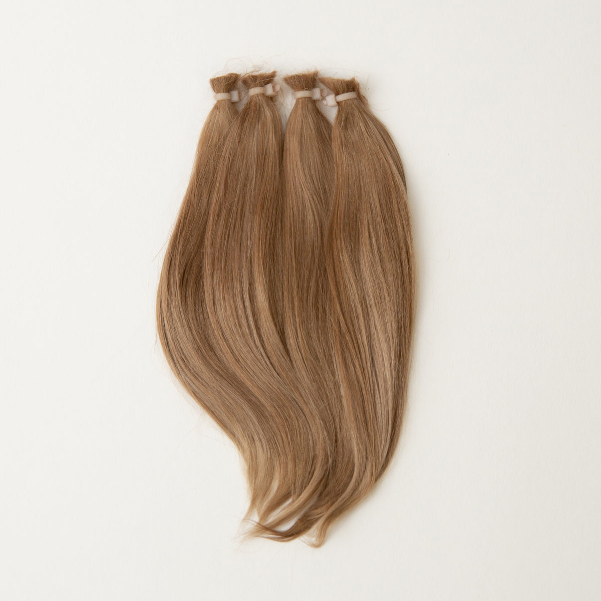 Three bundles of straight, honey blonde reborn mohair hair tied at the top, displayed against a plain white background.