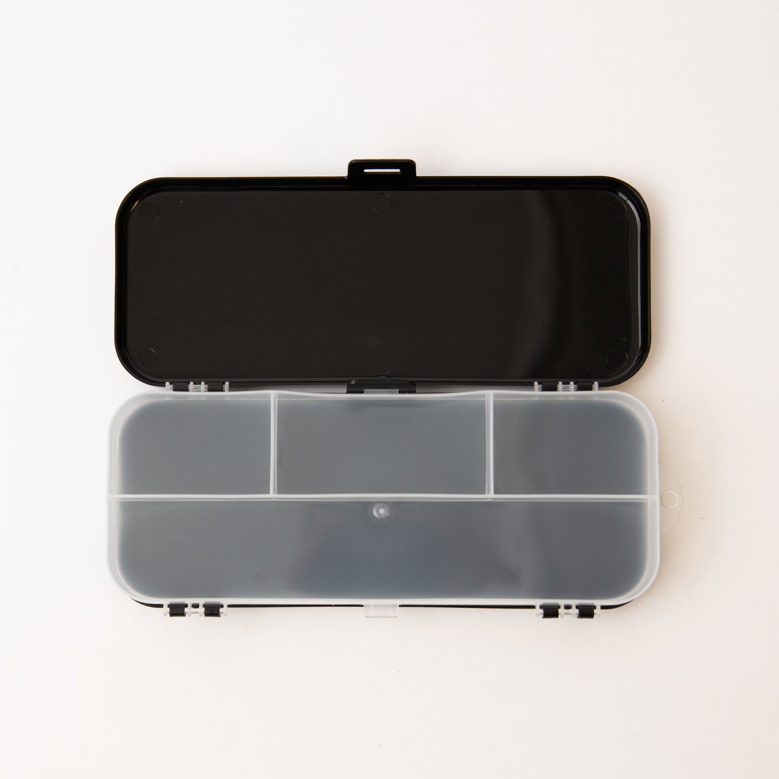Clear plastic case with black lid on a white background