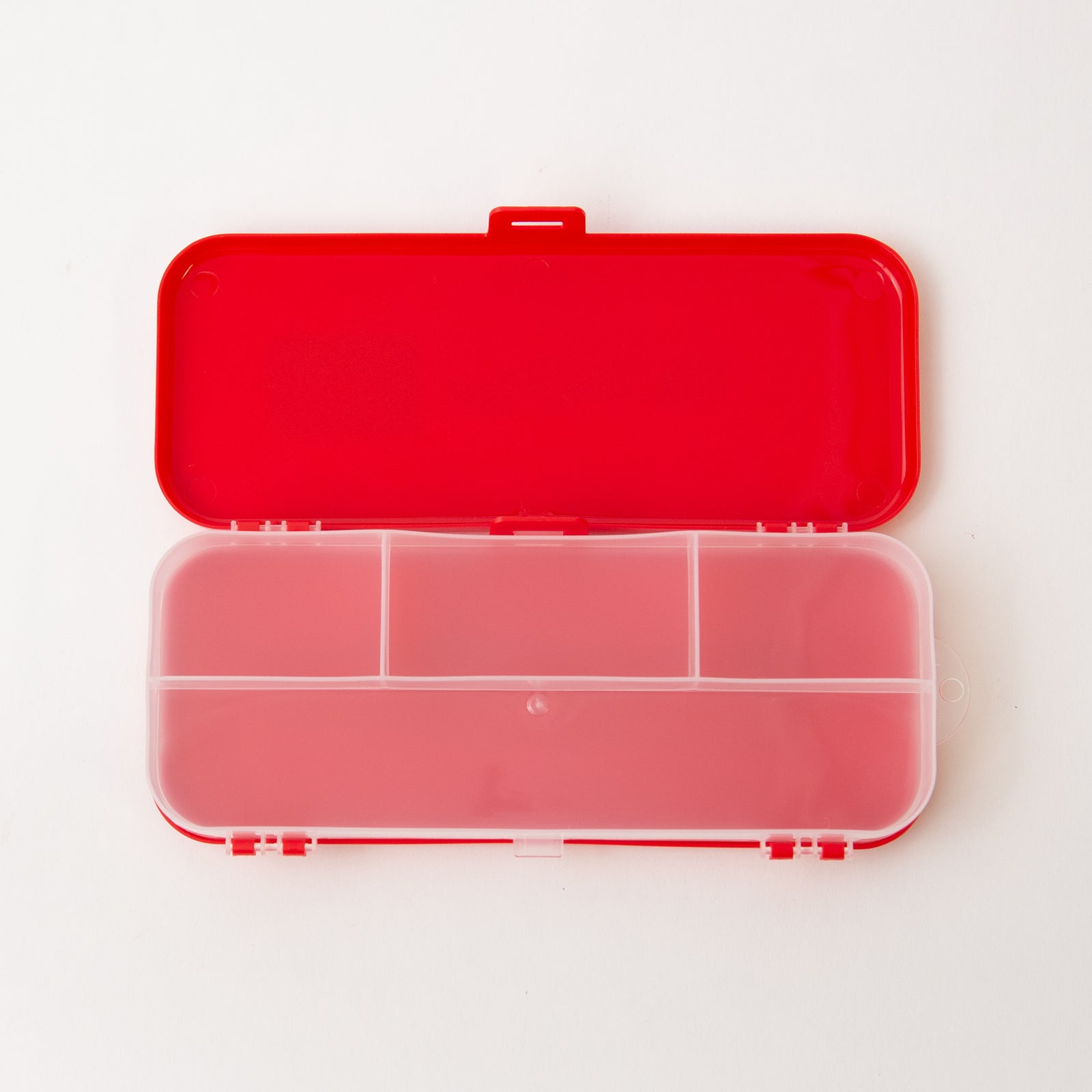 Red and clear plastic compartmentalized box on a white background