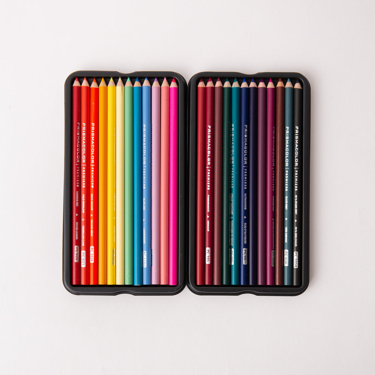 Two sets of colored pencils in a black case on a white background