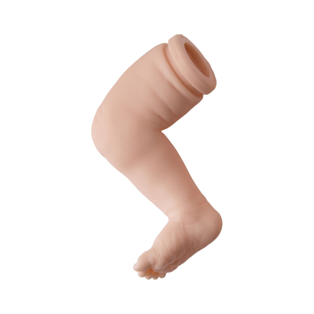 realistic vinyl baby doll leg on a white background