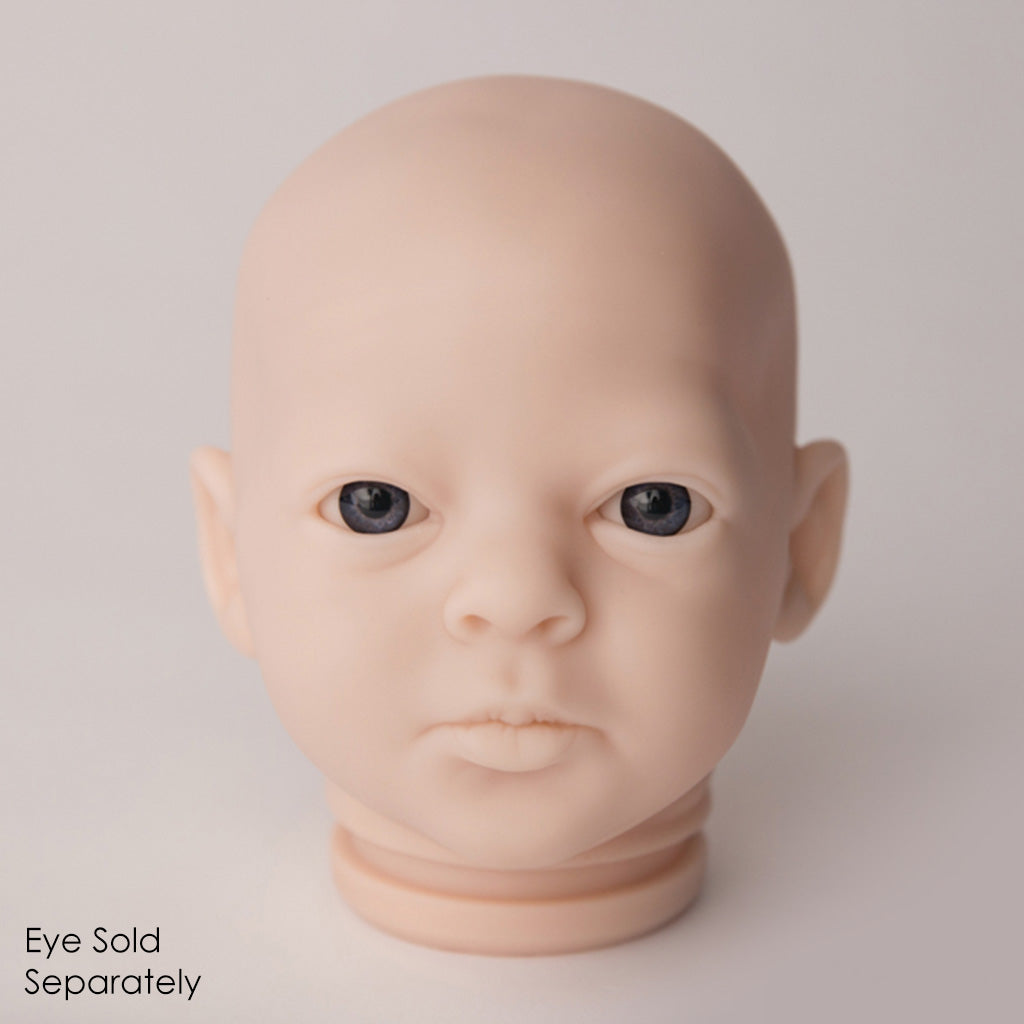 Baby doll head with eyes sold separately on a plain background