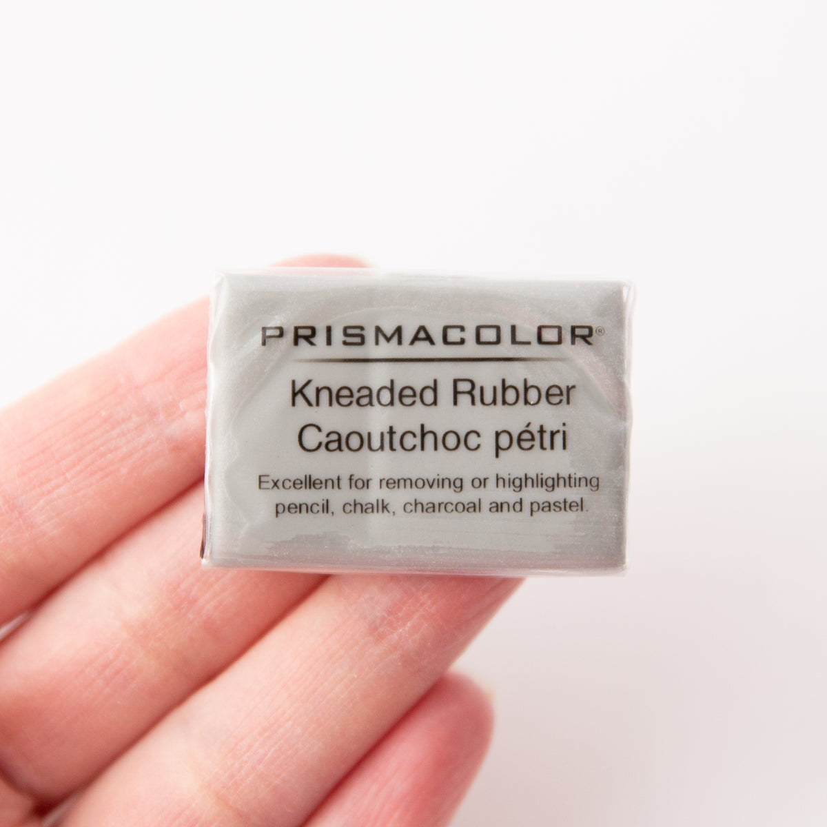 Prismacolor kneaded rubber eraser held in a hand against a white background